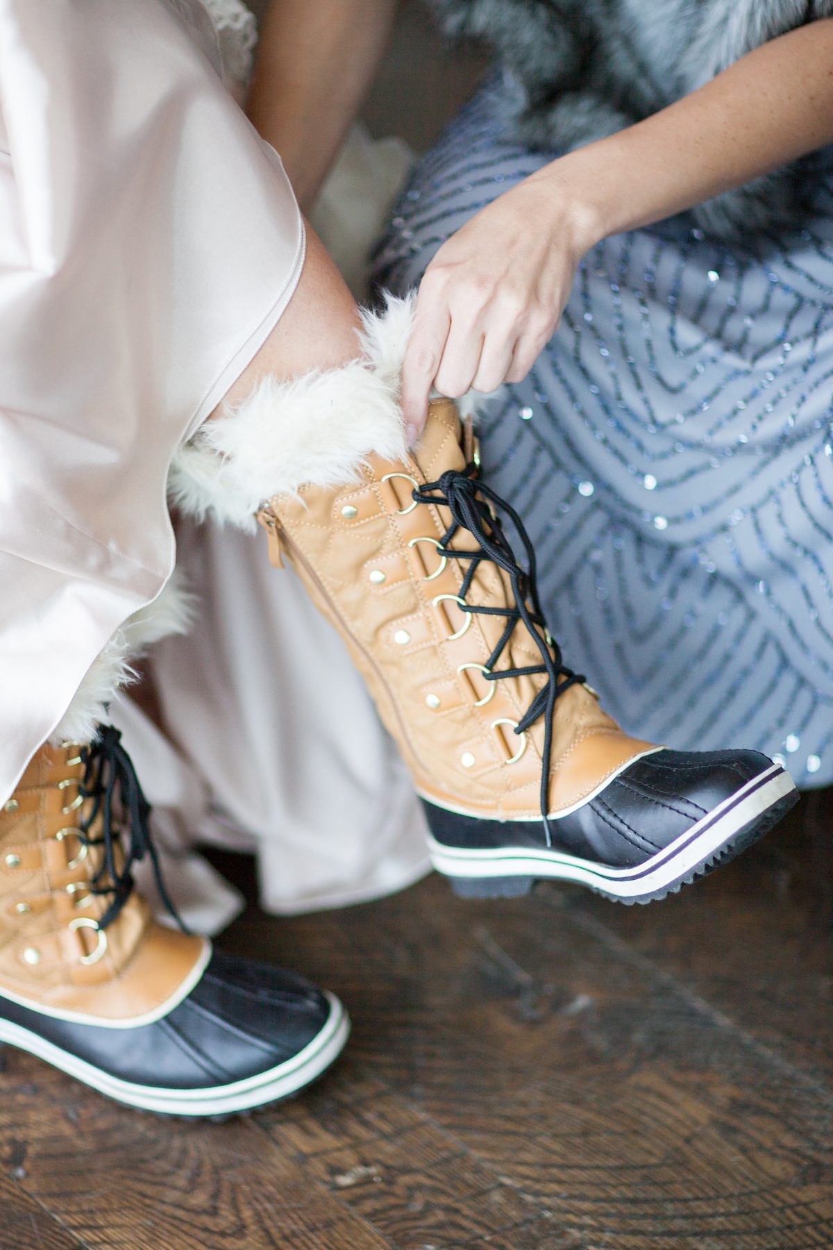Bride getting her snow boots on for a Colorado winter wedding, Winter Wedding Photography, Amy Caroline Photography