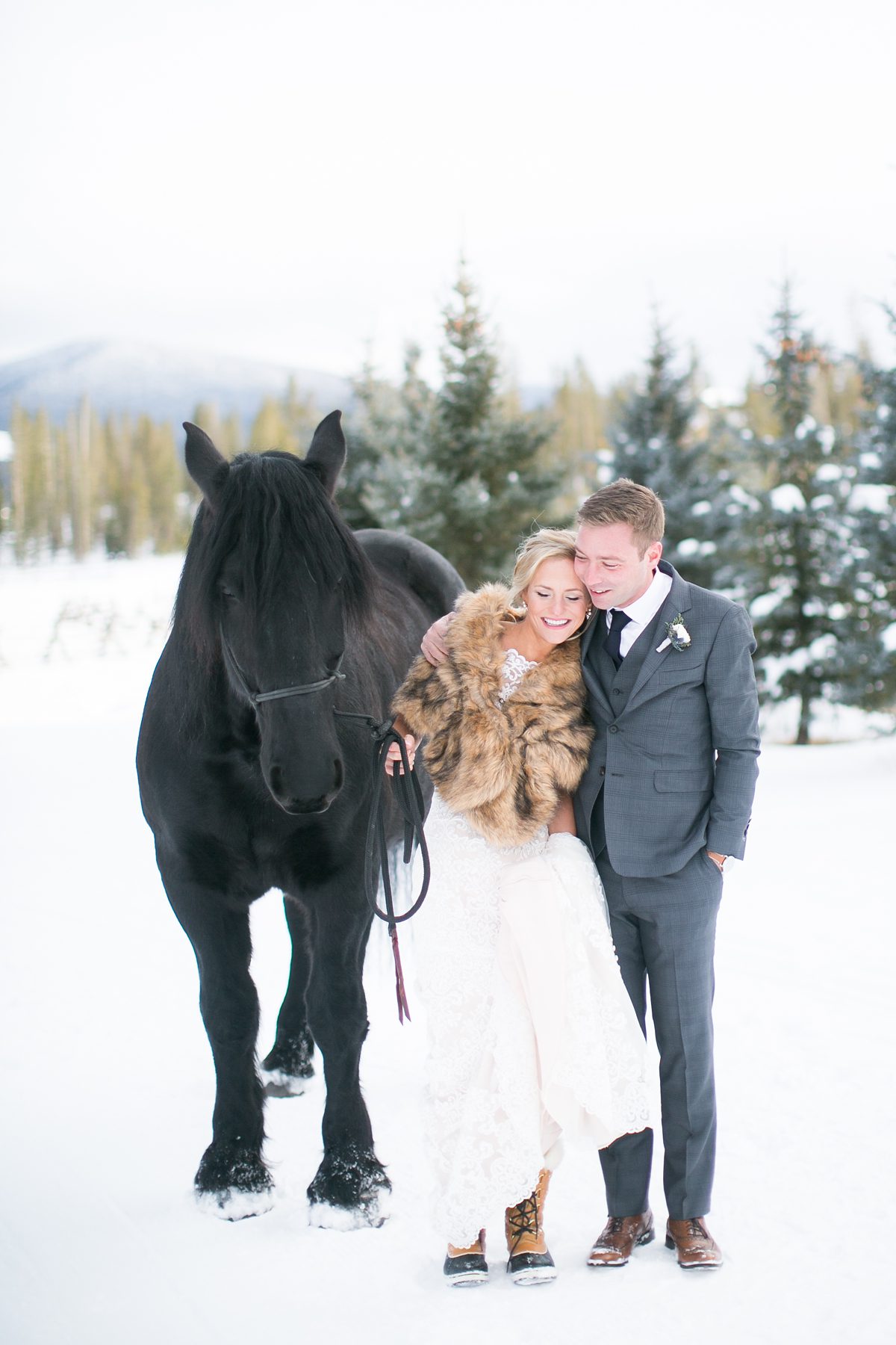 Happy Bride and Groom with a Horse, Wedding with a Horse, Colorado Winter Wedding with horses, Devils Thumb Ranch Wedding, Amy Caroline Photography