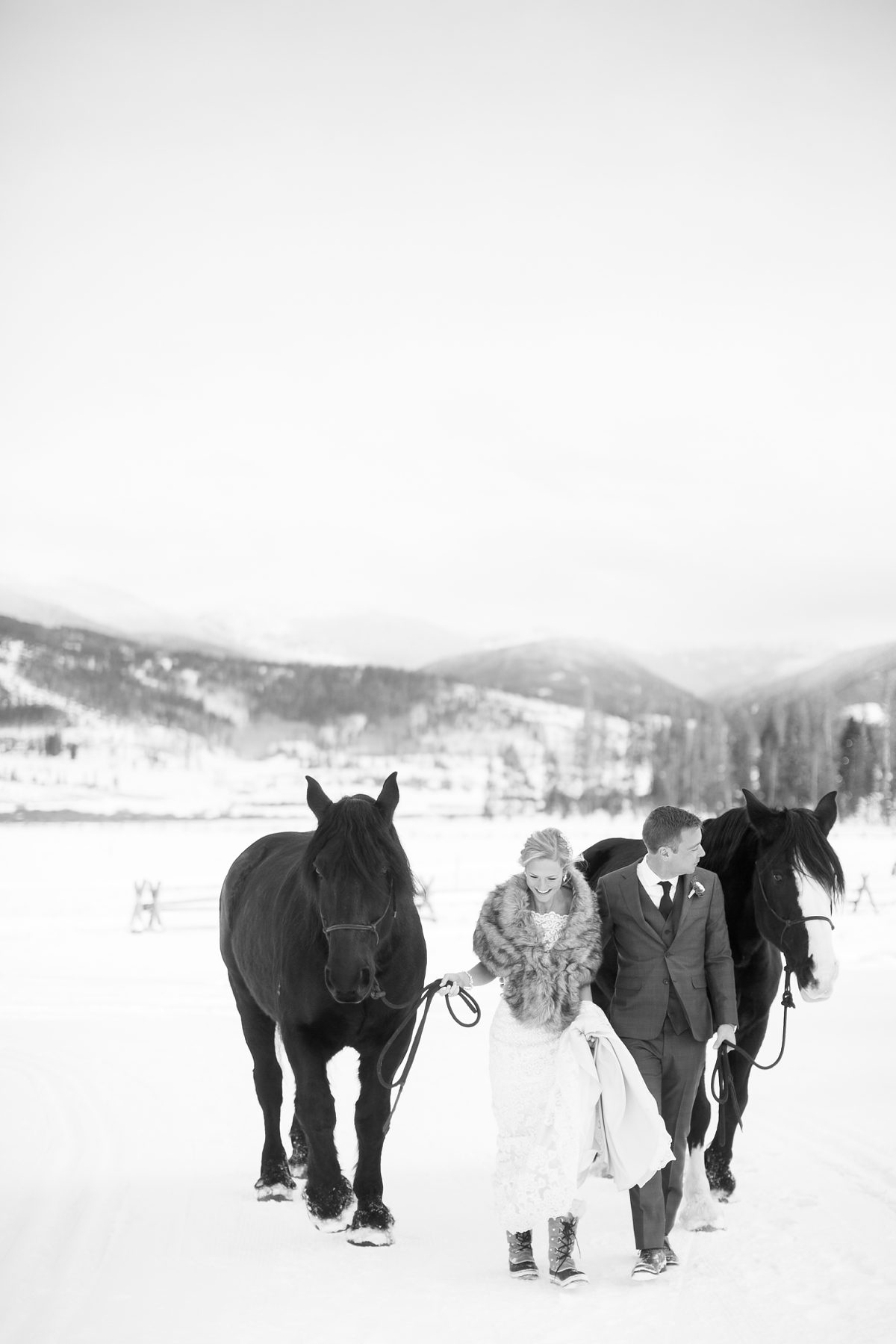 Bride and Groom in a Colorado Winter Wedding, Horses, Colorado Devils Thumb Ranch Winter Mountain Wedding, Amy Caroline Photography