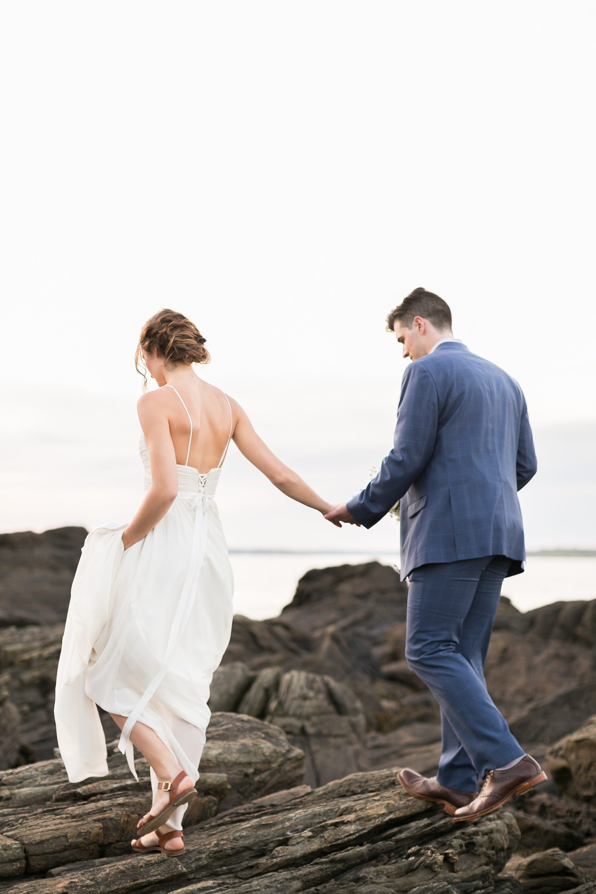 Bride and Groom Walk on the rocky coastline of Portland Maine at sunset, Maine Bride and Groom, Maine Coastal Wedding Photographers, Amy Caroline Photography 