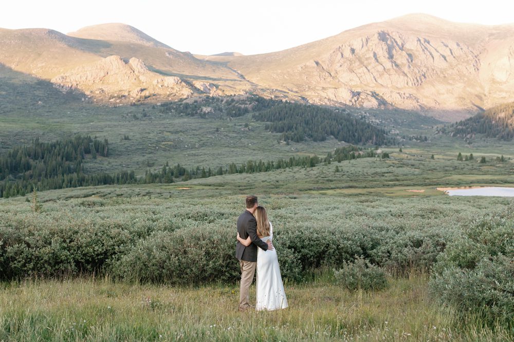 Joyful engaged couple walking through Georgetown, Colorado at golden hour