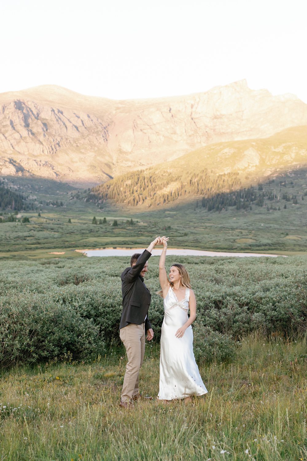 Reformation silky white dress. Golden Hour Mountain Engagement Session in Georgetown, Colorado by Amy Caroline Photography