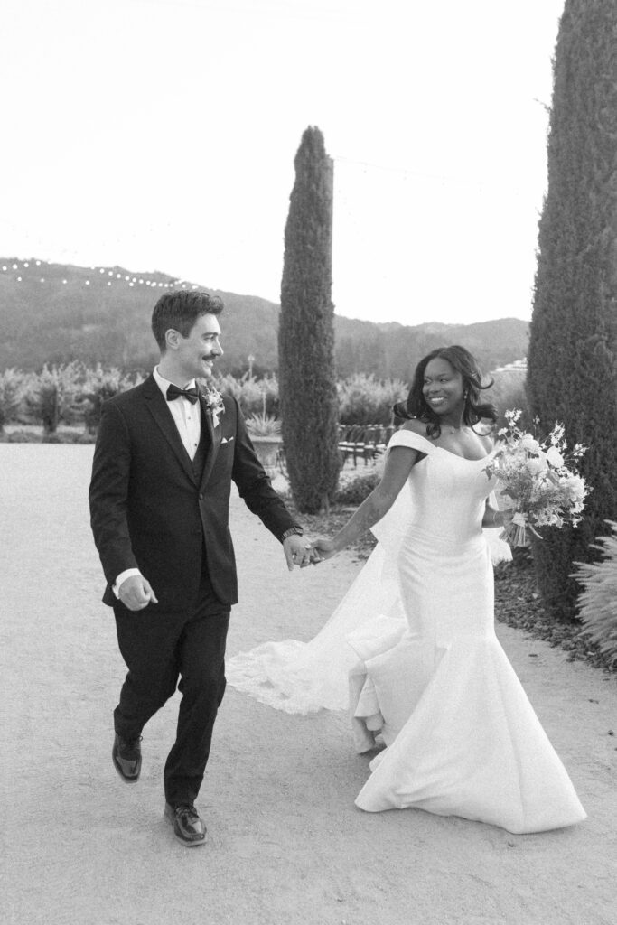Bride and groom among Napa Valley vineyard rows at their Tre Posti wedding in Saint Helena